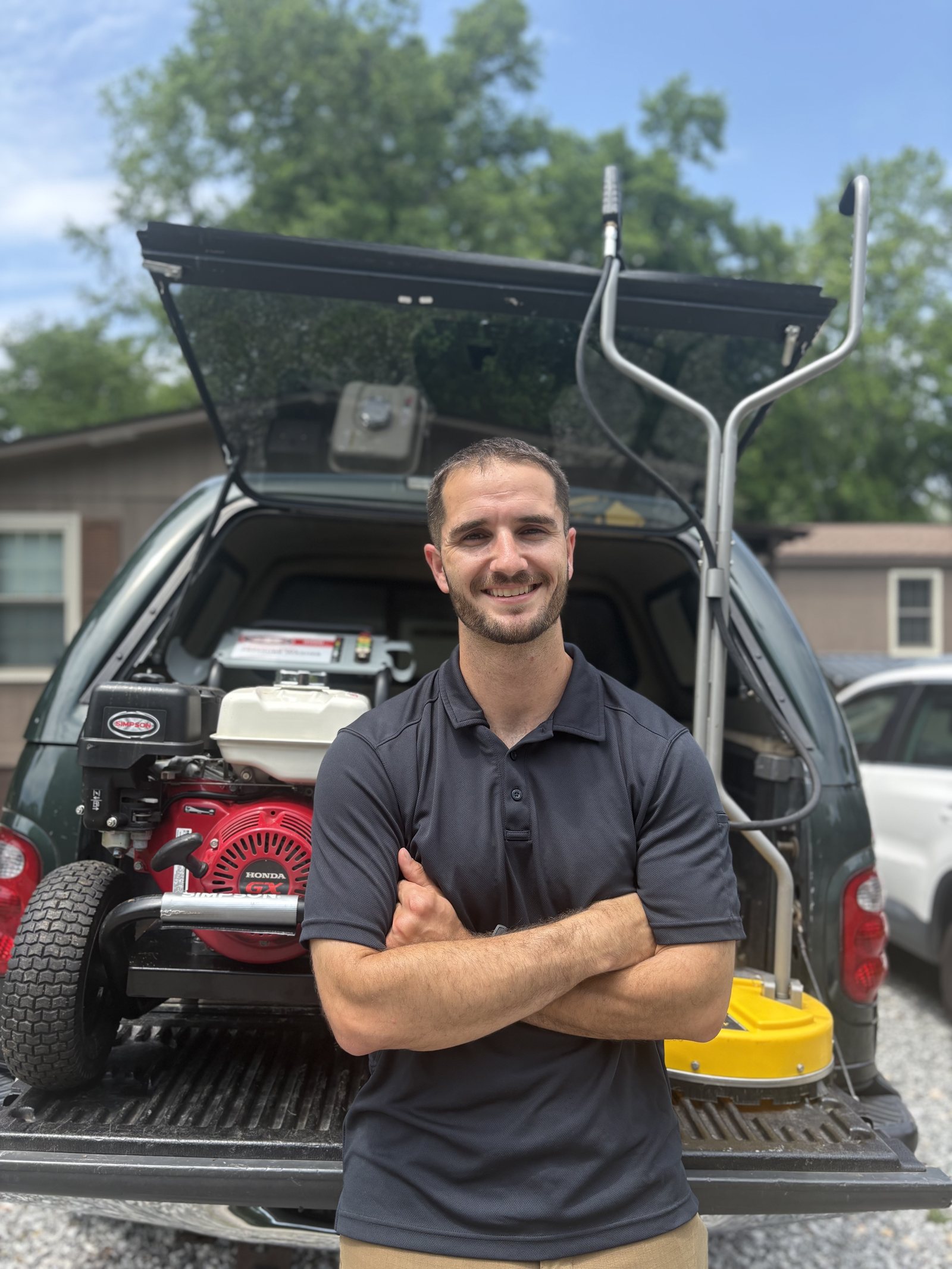Phil, owner of Kingdom Exterior Cleaning, standing with his pressure washing equipment in Greenville SC